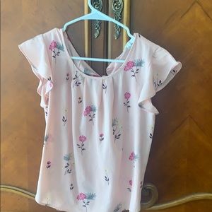 a baby pink with floral designs blouse